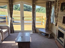 A living room with a sofa and coffee table at Cabin - Sleeps 6 - Outdoor Pool and Parking in Cenarth