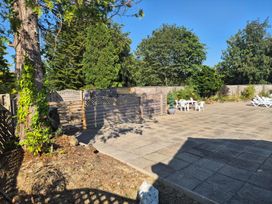A garden area with patio and outdoor furniture at Cabin - Sleeps 6 - Outdoor Pool and Parking Cenarth