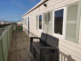 An outdoor area with a bench and windows at Snowdonia Sunbeach Holiday Sea and Mountain view, Llwyngwril