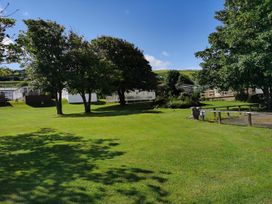 An outdoor area with caravans and trees at Snowdonia Sunbeach Holiday Sea and Mountain view in Llwyngwril
