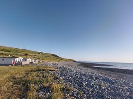 A scenic view of caravans by the sea at Snowdonia Sunbeach Holiday Sea and Mountain view in Llwyngwril