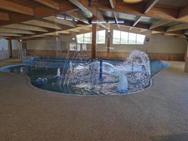 An indoor pool with water features at Snowdonia Sunbeach Holiday Sea and Mountain view in Llwyngwril