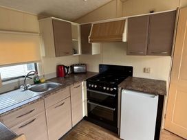 A kitchen with a sink and refrigerator at Seaside Tranquility Retreat in Clacton