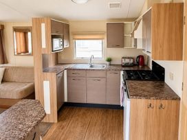 A kitchen with a sink and appliances at Seaside Tranquility Retreat in Clacton