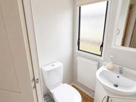 A bathroom with a toilet and sink at Seaside Tranquility Retreat in Clacton