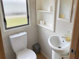 A bathroom with a toilet and washbasin at Seaside Tranquility Retreat in Clacton