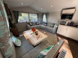 A living room with a seating area and a table at Wl34 Caravan Haggerston Castle Private Decking Haggerston