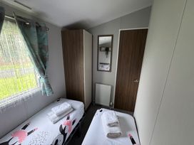 A bedroom with two beds and towels on top at Wl34 Caravan Haggerston Castle Private Decking Haggerston