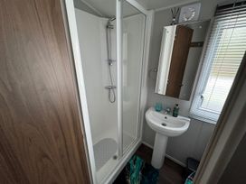 A bathroom with shower and sink at Wl34 Caravan Haggerston Castle Private Decking Haggerston