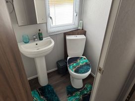 A bathroom with a wash basin and toilet at Wl34 Caravan Haggerston Castle Private Decking in Haggerston