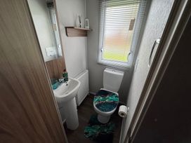 A bathroom with a sink and toilet at Wl34 Caravan Haggerston Castle Private Decking in Haggerston