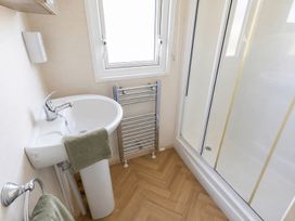A bathroom with a sink and shower at Caravan - Sleeps 8 - Parking, Northampton