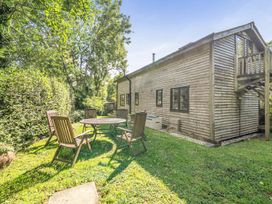 An outdoor area with a table and chairs at 3-Bed Barn Eco-Lodge on the Tarka trail East Yarde near Great Torrington