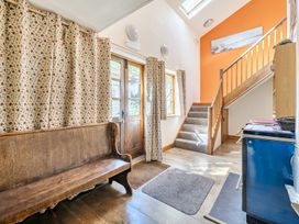 A hallway with a wooden bench and staircase at 3-Bed Barn Eco-Lodge on the Tarka trail East Yarde near Great Torrington