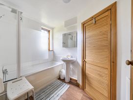 A bathroom with a bathtub and shower at 3-Bed Barn Eco-Lodge on the Tarka trail, East Yarde near Great Torrington