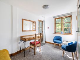 A room with a table and chairs at 3-Bed Barn Eco-Lodge on the Tarka trail, East Yarde near Great Torrington