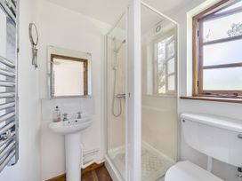A bathroom with a shower, sink, and toilet at 3-Bed Barn Eco-Lodge on the Tarka trail East Yarde near Great Torrington