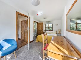 A bedroom with a bed and wooden furniture at 3-Bed Barn Eco-Lodge on the Tarka trail East Yarde near Great Torrington