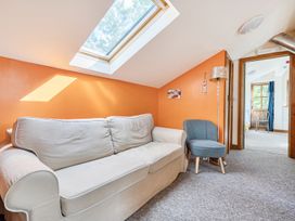 A living room with a sofa and an armchair at 3-Bed Barn Eco-Lodge on the Tarka trail in East Yarde near Great Torrington