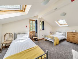 A bedroom with two beds and a wooden dresser at 3-Bed Barn Eco-Lodge on the Tarka trail East Yarde near Great Torrington