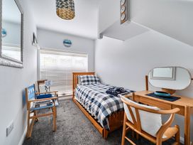 A bedroom with a bed, chair, and table at 1 Bed Cottage - Sleeps 2 - Wifi, Malpas near Truro