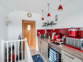 A kitchen with a sink and appliances at 1 Bed Cottage - Sleeps 2 - Wifi Malpas near Truro