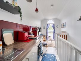 A kitchen with appliances and a window at 1 Bed Cottage - Sleeps 2 - Wifi in Malpas near Truro