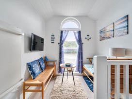 A living room with a sofa and table at 1 Bed Cottage - Sleeps 2 - Wifi Malpas near Truro