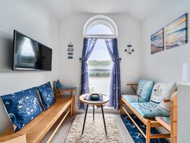 A living room with a television and seating area at 1 Bed Cottage - Sleeps 2 - Wifi near Malpas