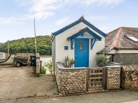 A building with a blue door and wooden fence at 1 Bed Cottage - Sleeps 2 - Wifi in Malpas near Truro