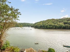 A view of a river with trees and boats at 1 Bed Cottage - Sleeps 2 - Wifi, Malpas near Truro