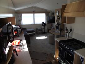 A living room with a sofa and coffee table at Seafront Caravan - Golden Sands - 6 Berth by Your Away Stays in Kinmel Bay