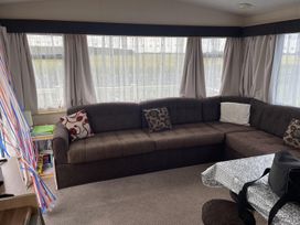 A snug with a brown sofa and table at 4 Bed Lodge Sleeps 8 - Pets & WiFi Free Parking in Ingoldmells