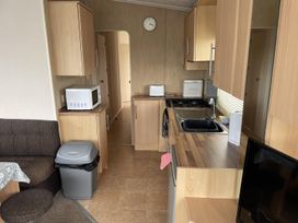 A kitchen with a microwave and stove at 4 Bed Lodge Sleeps 8 - Pets & WiFi Free Parking in Ingoldmells