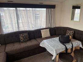 A living room with a sectional sofa and table at 4 Bed Lodge Sleeps 8 - Pets & WiFi Free Parking in Ingoldmells