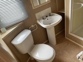 A bathroom with a sink and toilet at 4 Bed Lodge Sleeps 8 - Pets & WiFi Free Parking in Ingoldmells