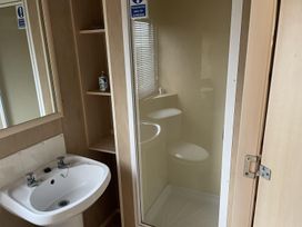A bathroom with a sink, toilet, and shower at 4 Bed Lodge Sleeps 8 - Pets & WiFi Free Parking in Ingoldmells
