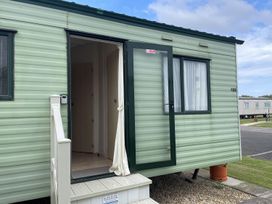 A caravan with steps and an open door at 4 Bed Lodge Sleeps 8 - Pets & WiFi Free Parking in Ingoldmells