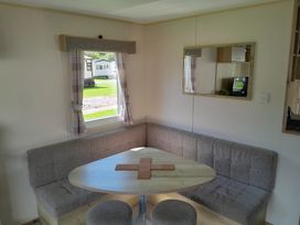 A dining area with a corner seating and table at Ye Old'e Man - Sleeps 6 & Pet Friendly near Flookburgh