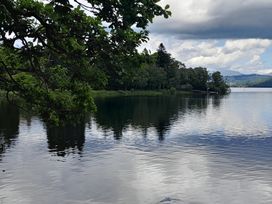 A lake with trees and clouds near Flookburgh