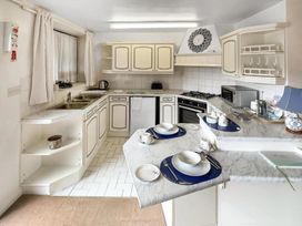 A kitchen with cabinets and appliances at Apartment Sleeps 2 with Parking, Pets Welcome in Watermillock near Pooley Bridge