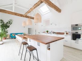 A kitchen with an island and seating area at Simple Coastal Luxury near Southwold sleeps 10 Near Southwold