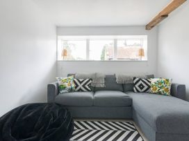 A snug area with a sofa and pillows at Simple Coastal Luxury near Southwold sleeps 10 near Southwold