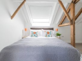 A bedroom with a bed and pillows at Simple Coastal Luxury near Southwold sleeps 10 near Southwold