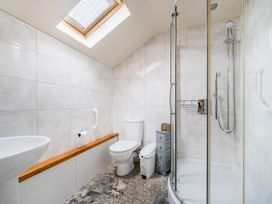 A bathroom with shower, toilet, and sink at The Shippon, Breathtaking Views, Private Hot Tub Winkleigh