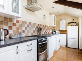 A kitchen with appliances on the counter at The Shippon, Breathtaking Views, Private Hot Tub Winkleigh