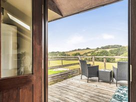 A deck with seating and a view at The Shippon, Breathtaking Views, Private Hot Tub in Winkleigh