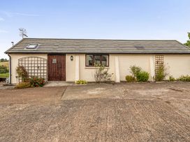 An exterior view of a property with a door and windows at The Shippon, Breathtaking Views, Private Hot Tub, Winkleigh