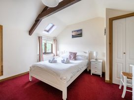 A bedroom with a bed and bedside table at The Shippon, Breathtaking Views, Private Hot Tub, Winkleigh