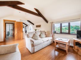 A living room with a sofa and side table at The Shippon, Breathtaking Views, Private Hot Tub in Winkleigh